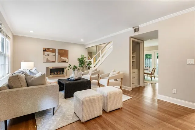 a living room with furniture fireplace and a window