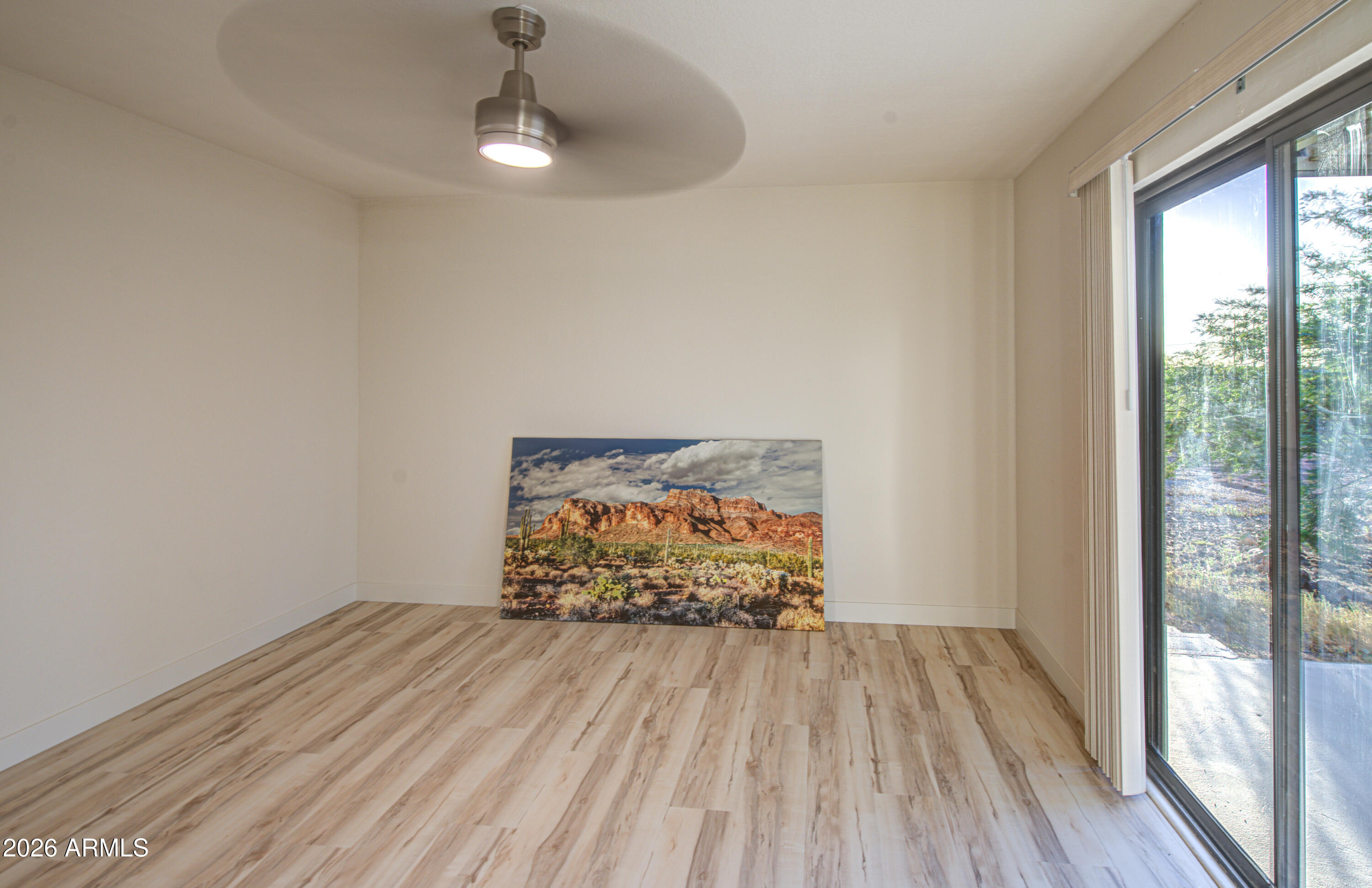 1350 North Boyd Road Apache Junction, AZ 85119 - Photo 14 of 31 a view of empty room with wooden floor and fan