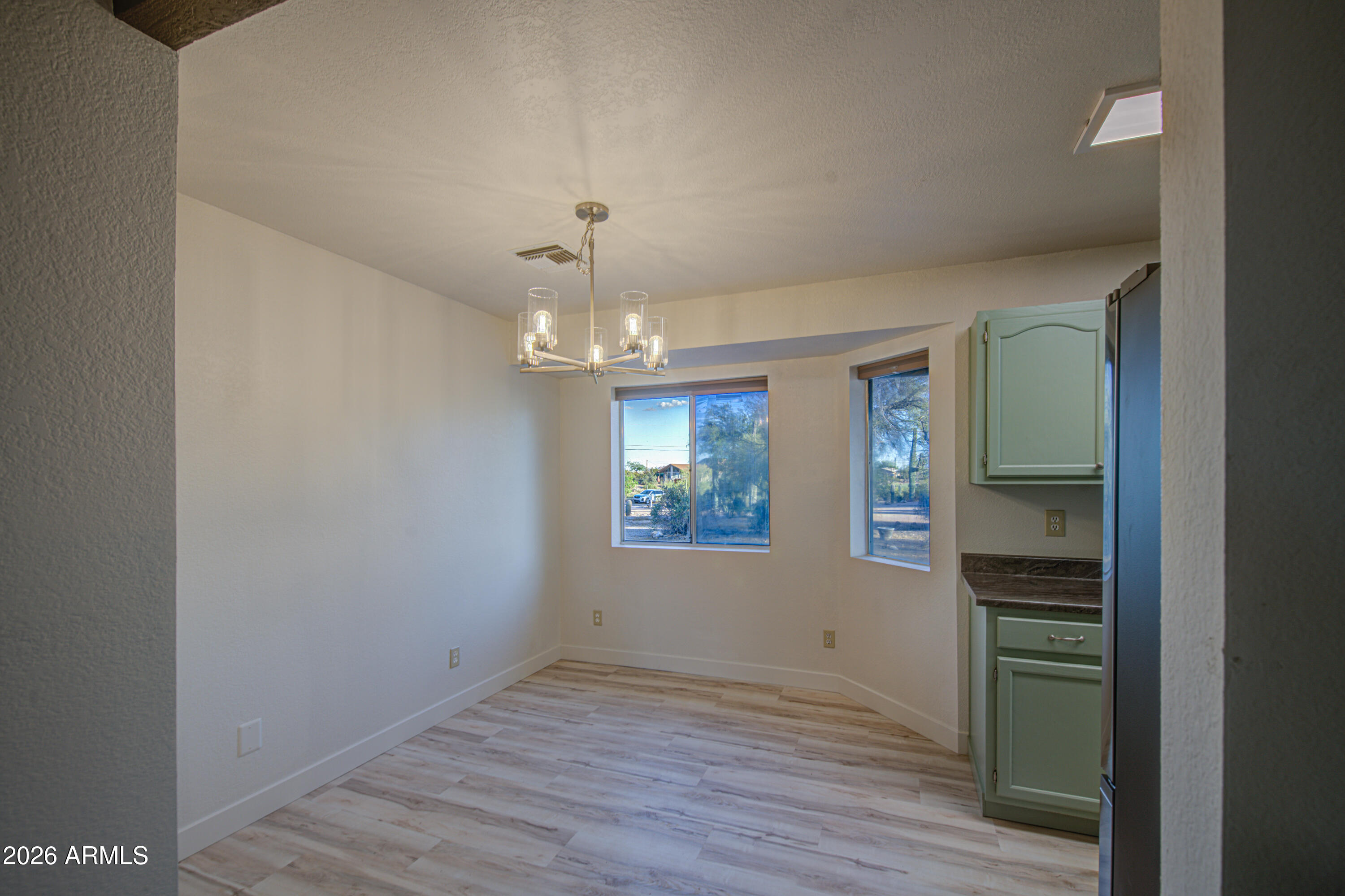 1350 North Boyd Road Apache Junction, AZ 85119 - Photo 6 of 31 wooden floor in an empty room with a window