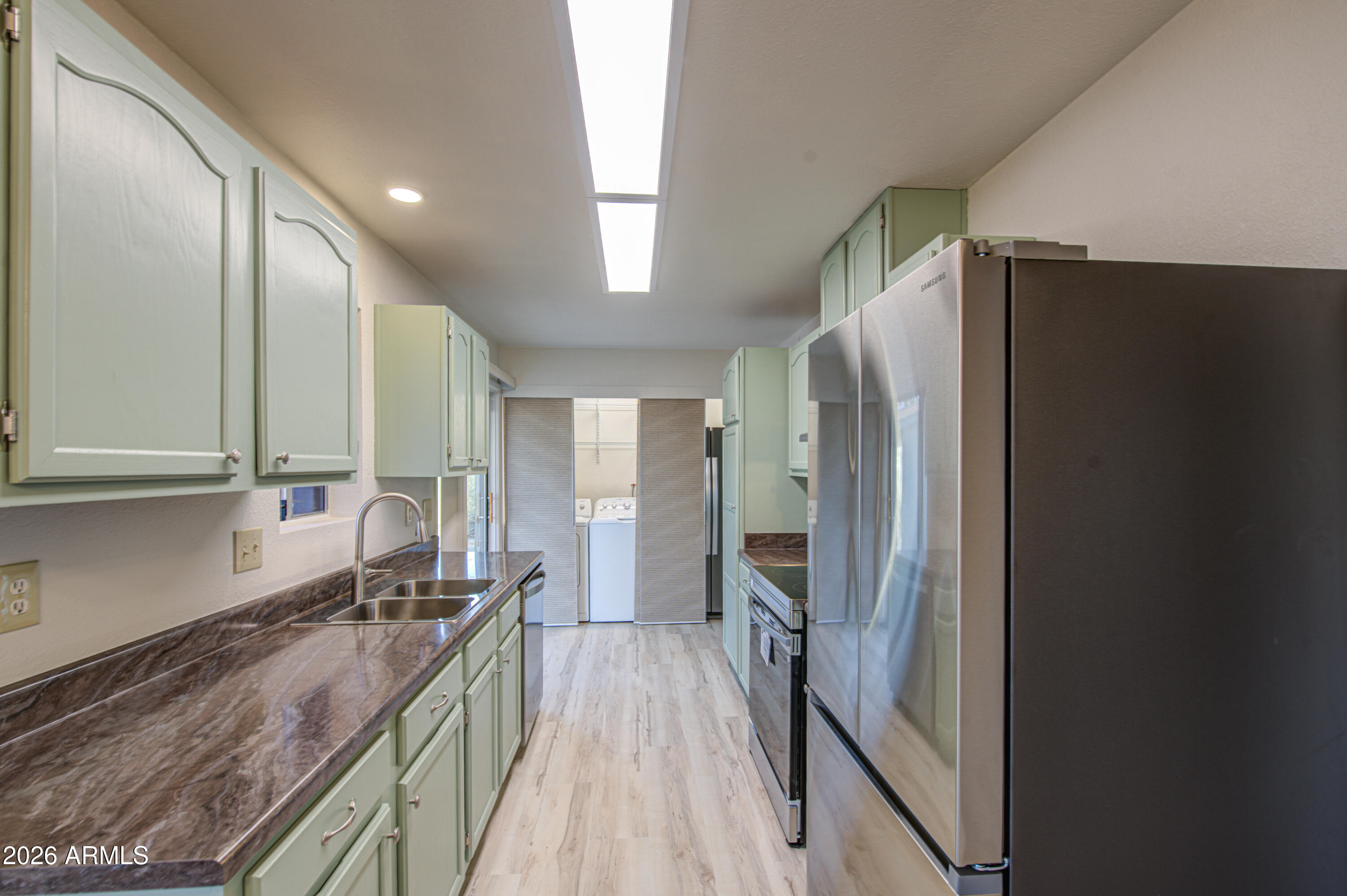1350 North Boyd Road Apache Junction, AZ 85119 - Photo 9 of 31 a kitchen with granite countertop a refrigerator and a sink