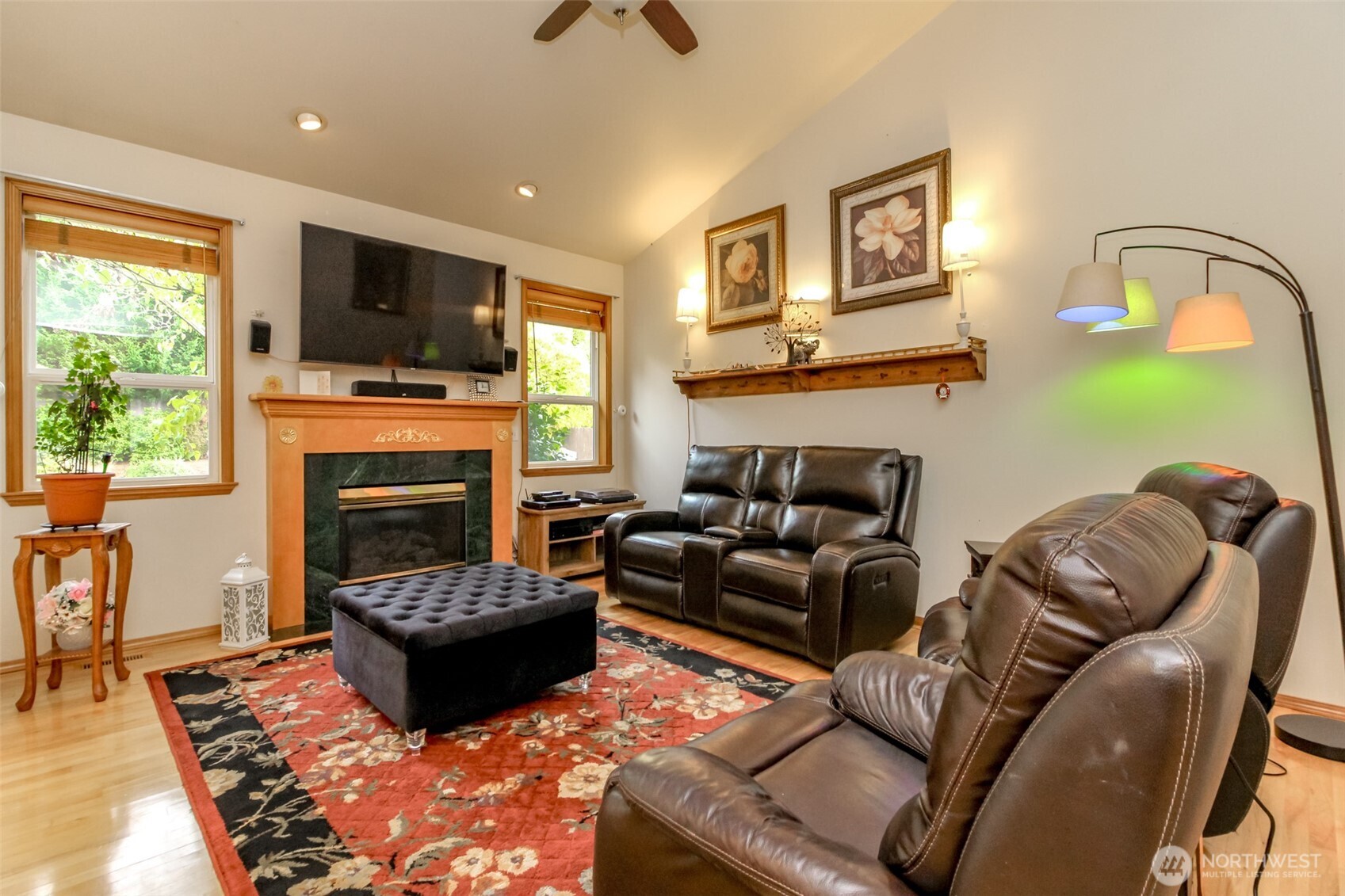 15405 148th Ave Court East Orting, WA 98360 - Photo 7 of 39 a living room with furniture a flat screen tv and a fireplace