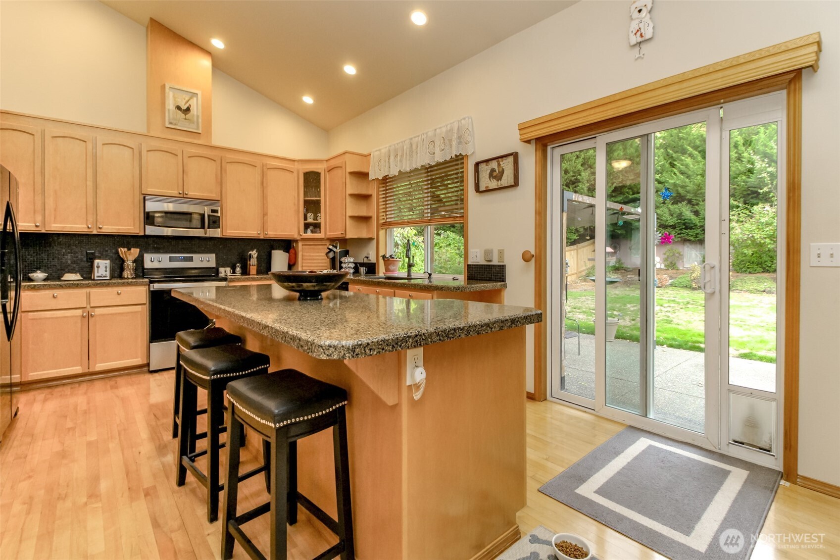 15405 148th Ave Court East Orting, WA 98360 - Photo 10 of 39 a kitchen with stainless steel appliances granite countertop sink stove and wooden cabinets