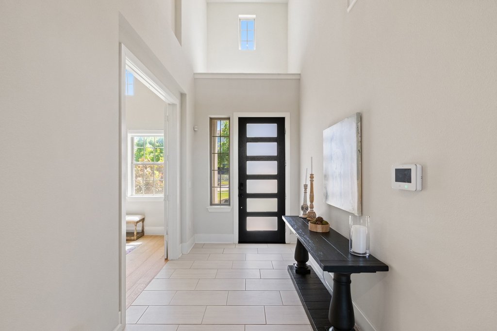 741 Rawson Bend Austin, TX 78738 - Photo 19 of 40 The foyer sits under two-story soaring ceilings open to the second floor above.