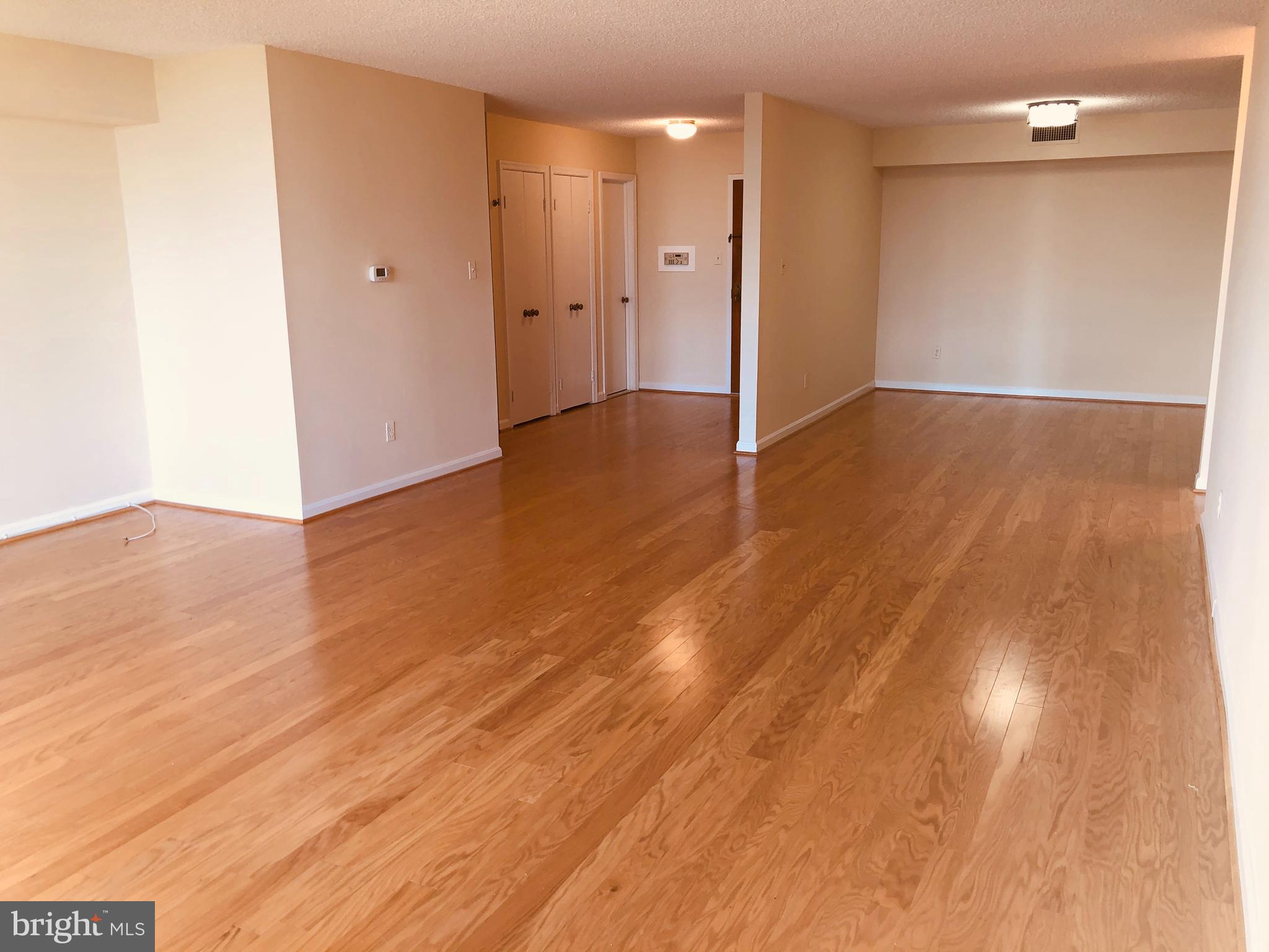 1101 South Arlington Ridge Road, Unit 704 Arlington, VA 22202 - Photo 11 of 41 a view of an empty room with wooden floor