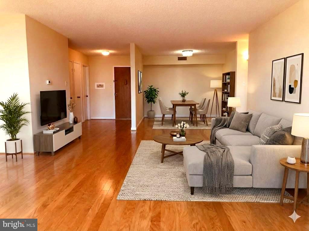 1101 South Arlington Ridge Road, Unit 704 Arlington, VA 22202 - Photo 12 of 41 a living room with furniture and a flat screen tv