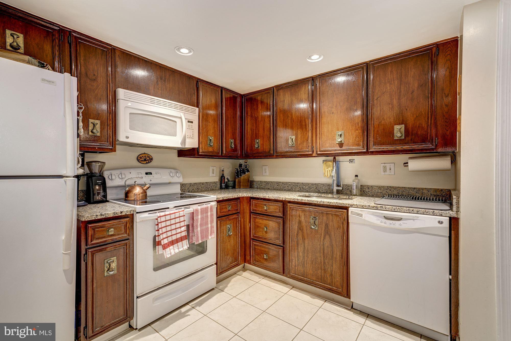 1101 South Arlington Ridge Road, Unit 704 Arlington, VA 22202 - Photo 14 of 41 a kitchen with a sink cabinets and wooden floor