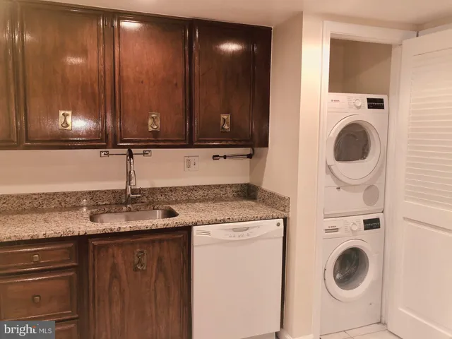 a kitchen with a sink a stove and cabinets