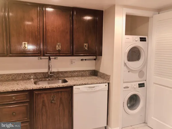 a kitchen with a sink a stove and cabinets