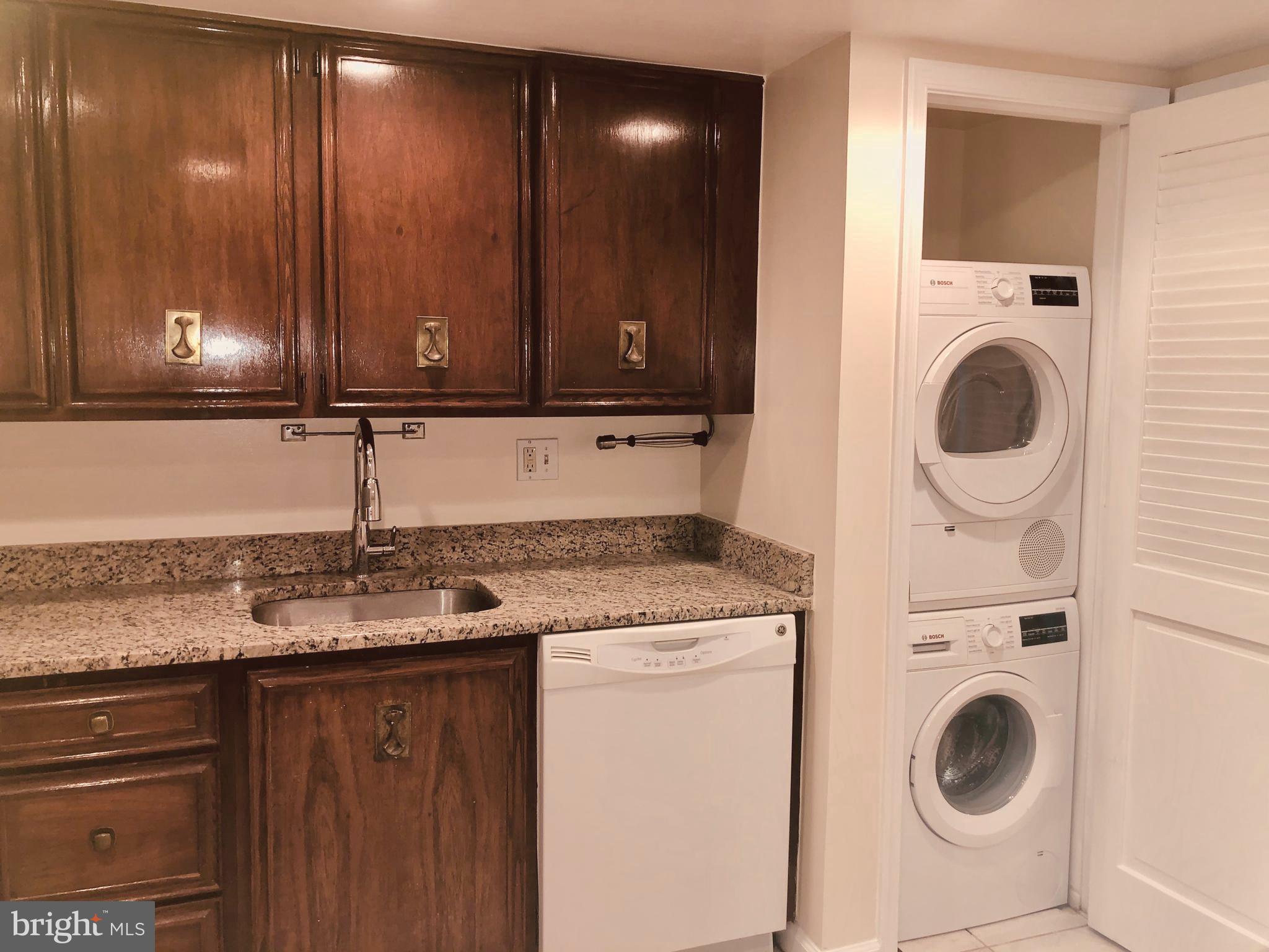 1101 South Arlington Ridge Road, Unit 704 Arlington, VA 22202 - Photo 16 of 41 a kitchen with a sink a stove and cabinets