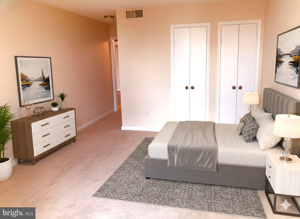 1101 South Arlington Ridge Road, Unit 704 Arlington, VA 22202 - Photo 26 of 41 a bedroom with a bed and a night stand