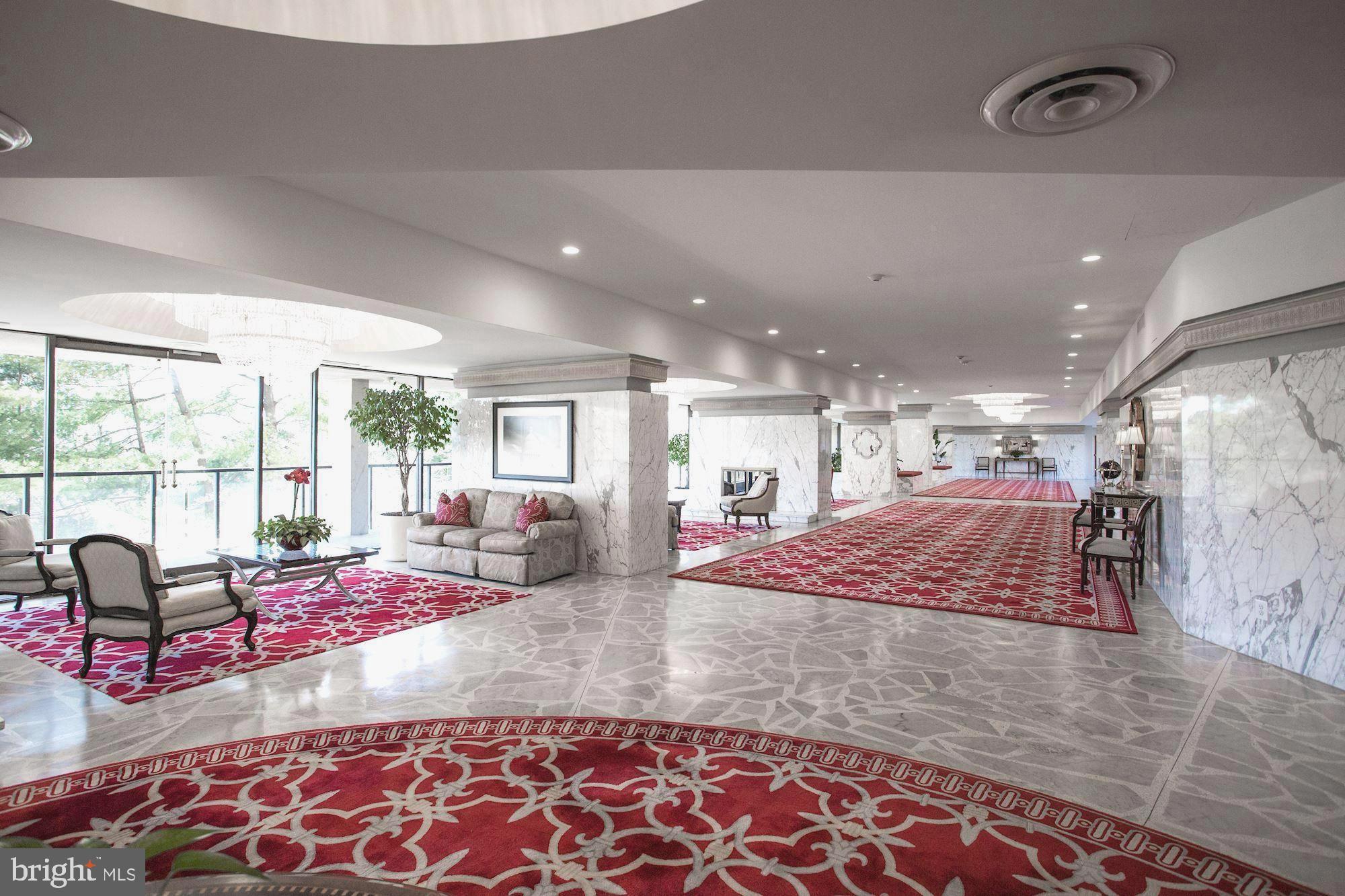 1101 South Arlington Ridge Road, Unit 704 Arlington, VA 22202 - Photo 5 of 37 a room with lots of windows and couch