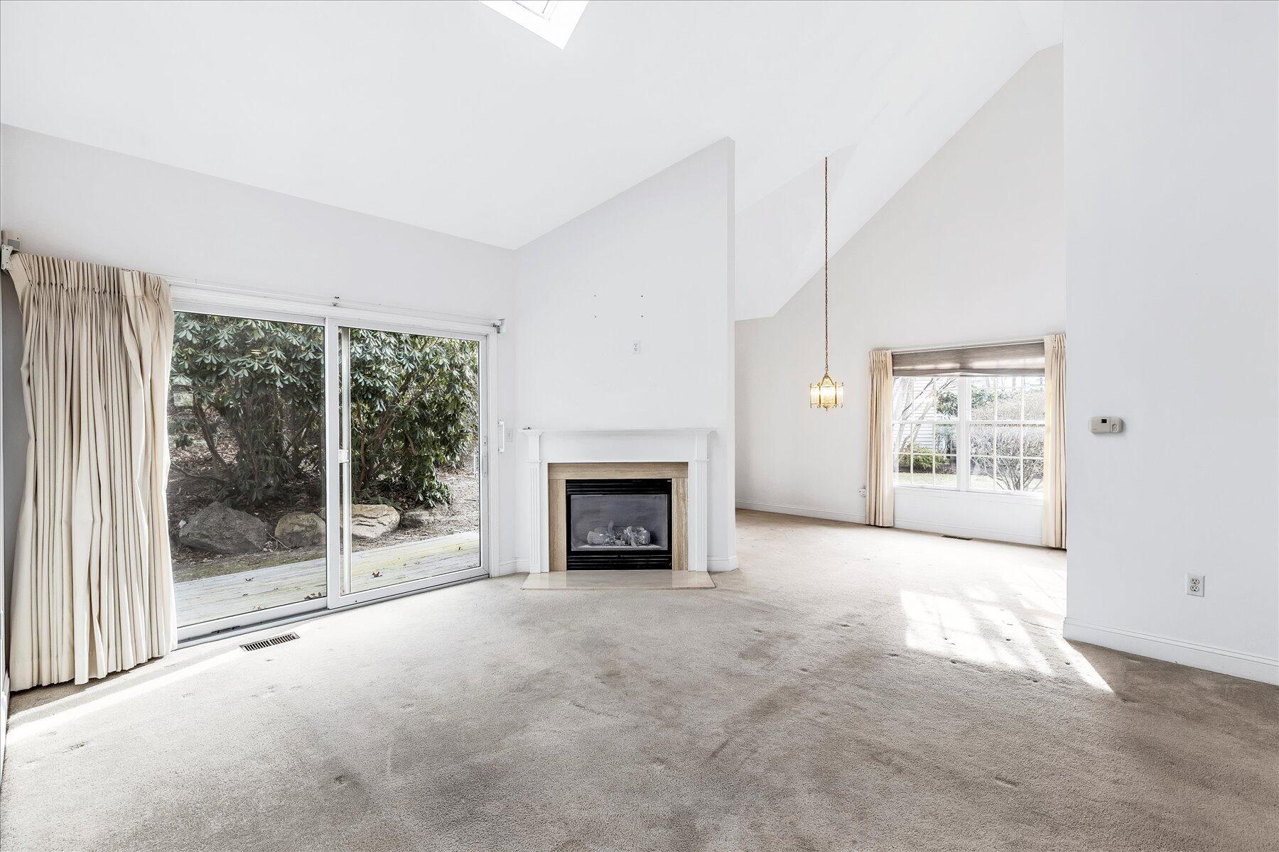 14 Bishops Park Mashpee, MA 02649 - Photo 14 of 42 a view of an empty room with a fireplace and a window