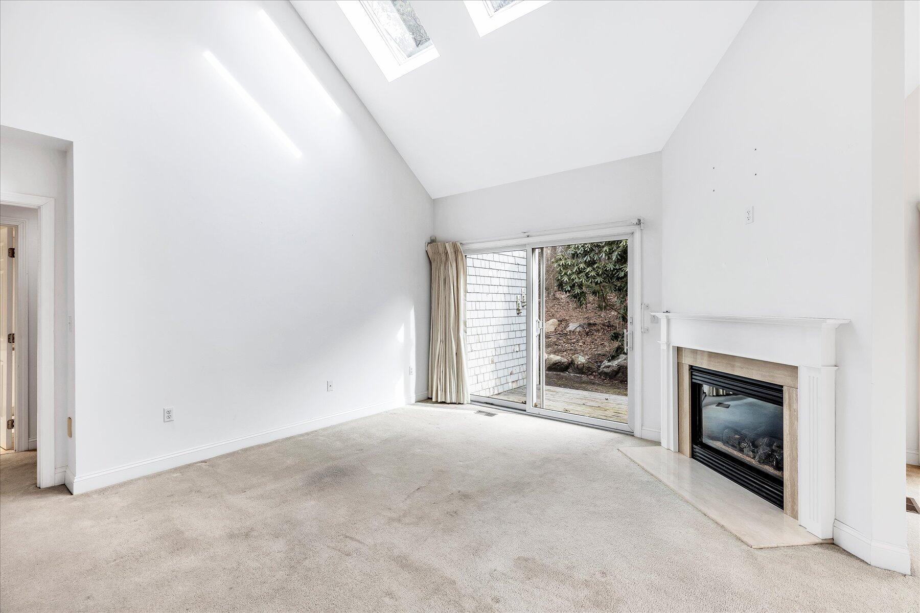 14 Bishops Park Mashpee, MA 02649 - Photo 17 of 42 a view of empty room with a fireplace