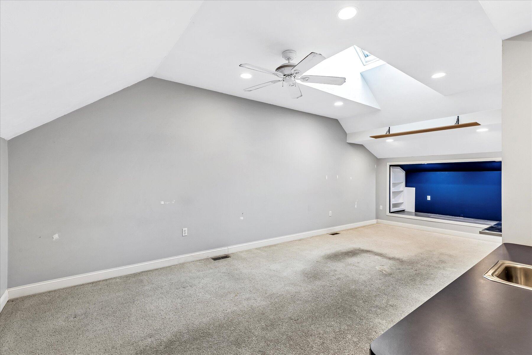 14 Bishops Park Mashpee, MA 02649 - Photo 26 of 42 an empty room with a chandelier fan and a window