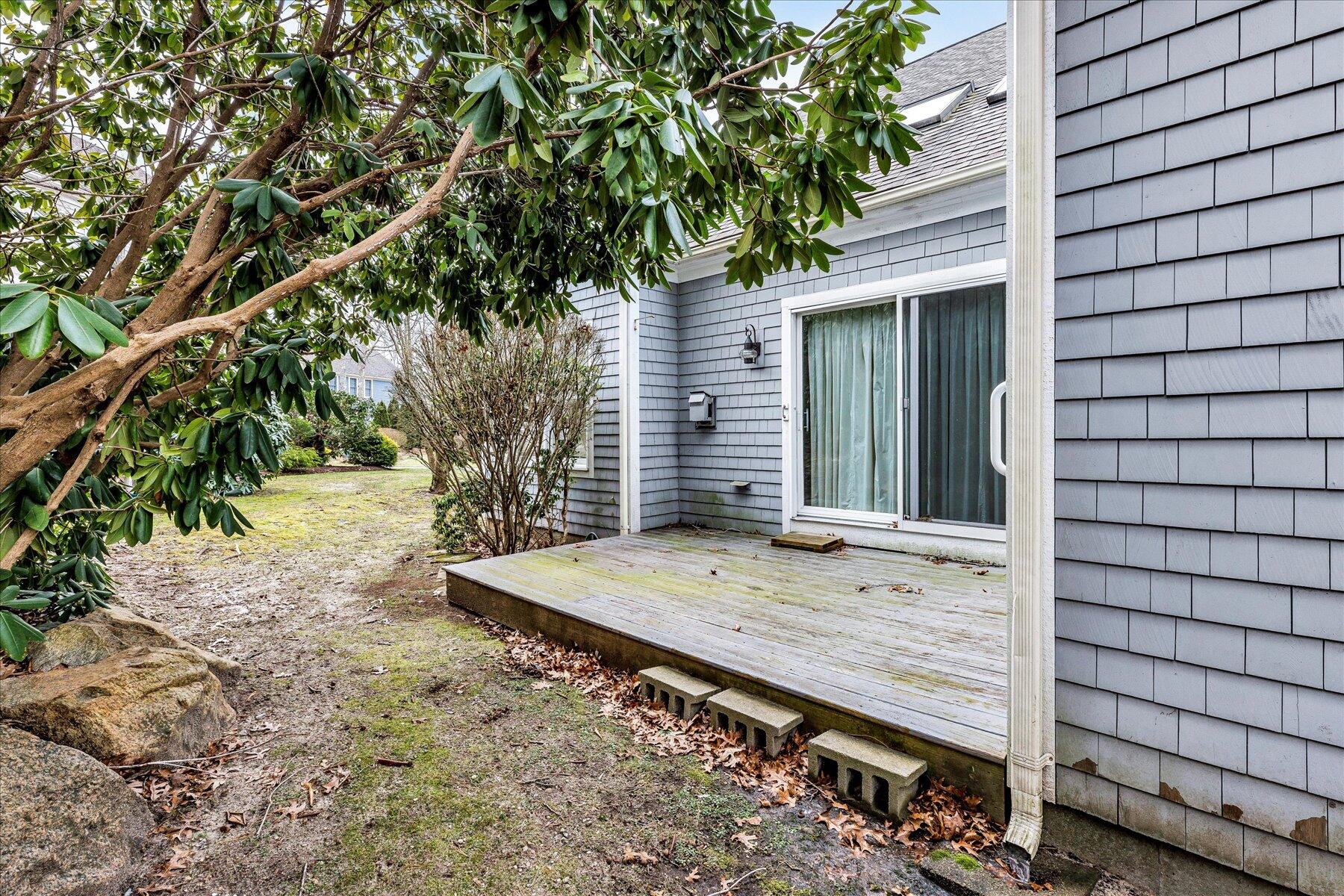 14 Bishops Park Mashpee, MA 02649 - Photo 40 of 42 a view of a wooden house with a tree