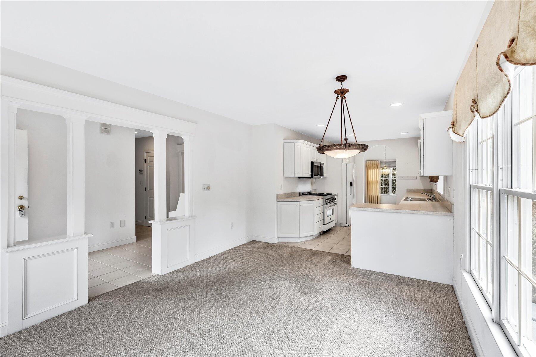 14 Bishops Park Mashpee, MA 02649 - Photo 6 of 42 a view of a kitchen with refrigerator and white cabinets