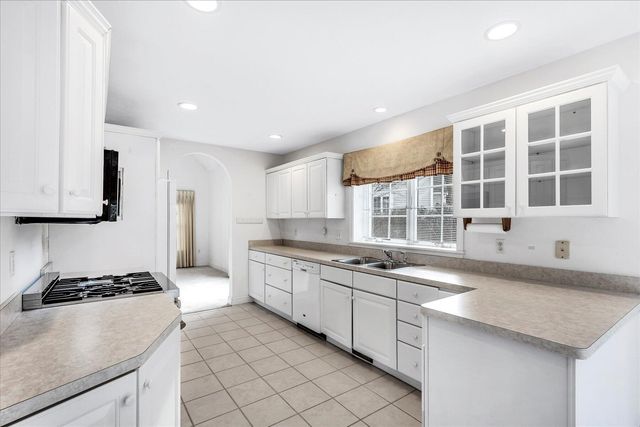 a large kitchen with a sink and cabinets