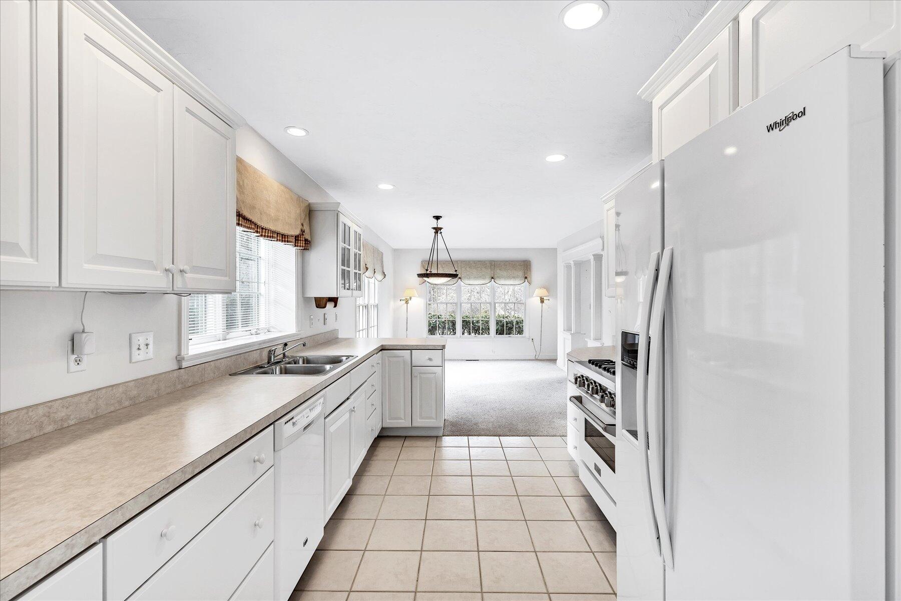 14 Bishops Park Mashpee, MA 02649 - Photo 10 of 42 a large kitchen with a sink and cabinets