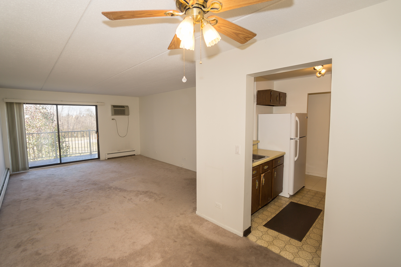 300 West Fullerton Avenue, Unit 305 Addison, IL 60101 - Photo 11 of 18 a view of a kitchen with an entryway and a ceiling fan