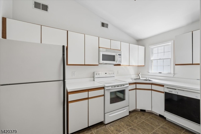 20 Alexandria Way Bernards, NJ 07920 - Photo 11 of 26 a kitchen with white cabinets and white appliances