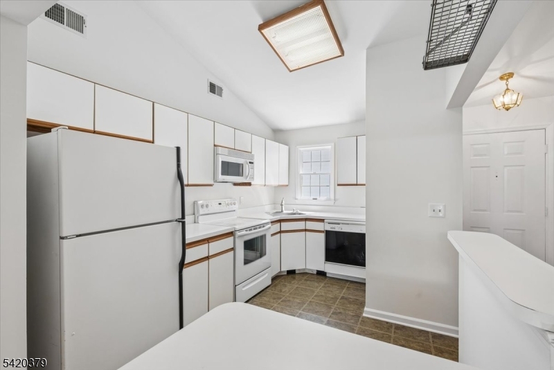 20 Alexandria Way Bernards, NJ 07920 - Photo 12 of 26 a kitchen with stainless steel appliances a refrigerator sink and microwave