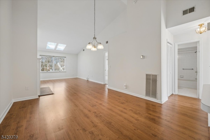 20 Alexandria Way Bernards, NJ 07920 - Photo 4 of 26 an empty room with wooden floor and windows