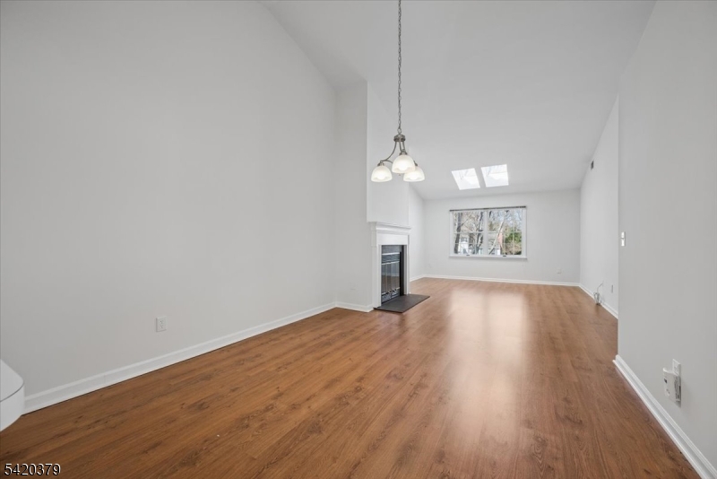 20 Alexandria Way Bernards, NJ 07920 - Photo 5 of 26 a view of an empty room with window and wooden floor
