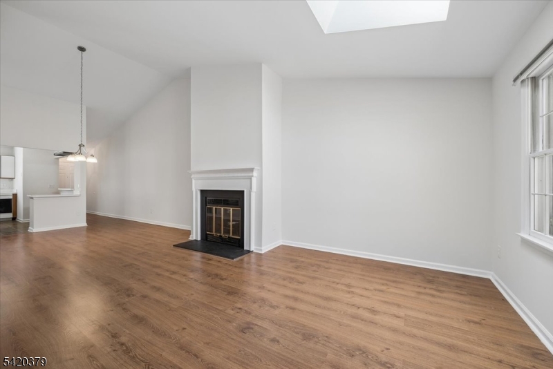 20 Alexandria Way Bernards, NJ 07920 - Photo 8 of 26 a view of empty room with wooden floor and fireplace
