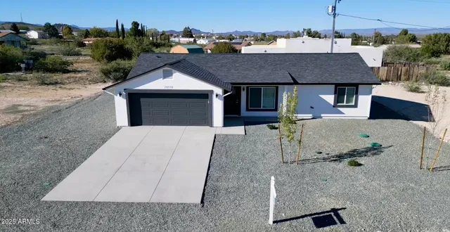 an aerial view of a house with yard