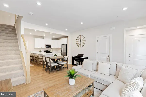 a living room with furniture kitchen view and a table