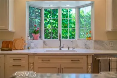 a kitchen with granite countertop a sink and a window
