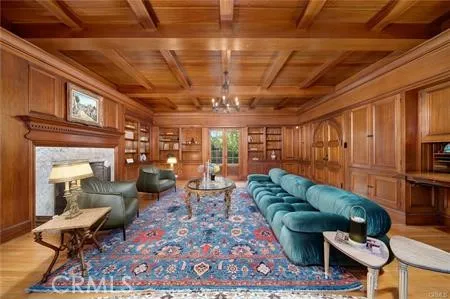 a living room with furniture a rug and a chandelier