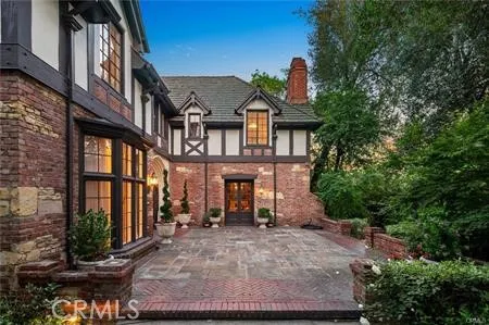 front view of a brick house with a yard