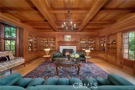 a living room with furniture a rug and a chandelier