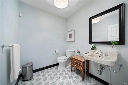 a bathroom with a double vanity sink mirror and toilet