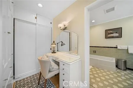 a bathroom with a sink a mirror and a bath tub