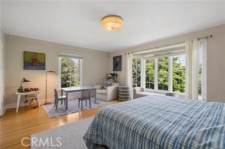 a bedroom with a bed and a large window