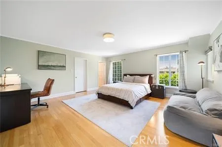 a bedroom with a bed window and a desk