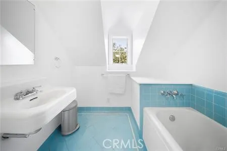 a bathroom with a bathtub and sink