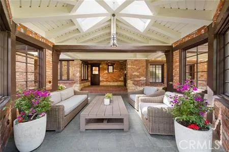a living room with furniture and large windows