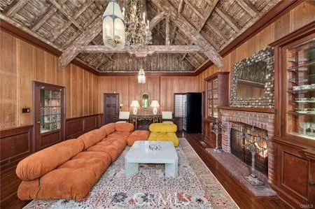 a living room with furniture a chandelier and a large window