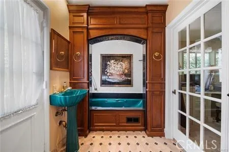 a view of a backyard with plants and brick wall