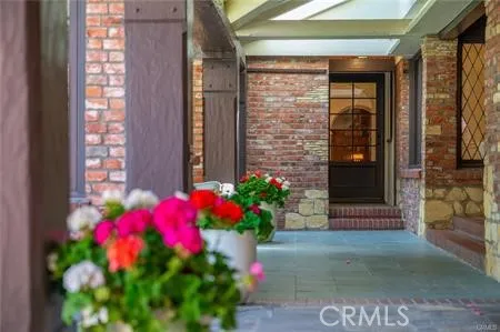 a backyard of a house with plants and large trees