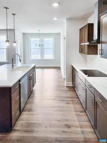a kitchen with stainless steel appliances granite countertop a sink and a wooden floors