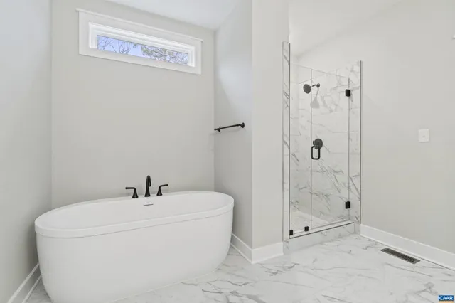 a bathroom with a bathtub and shower