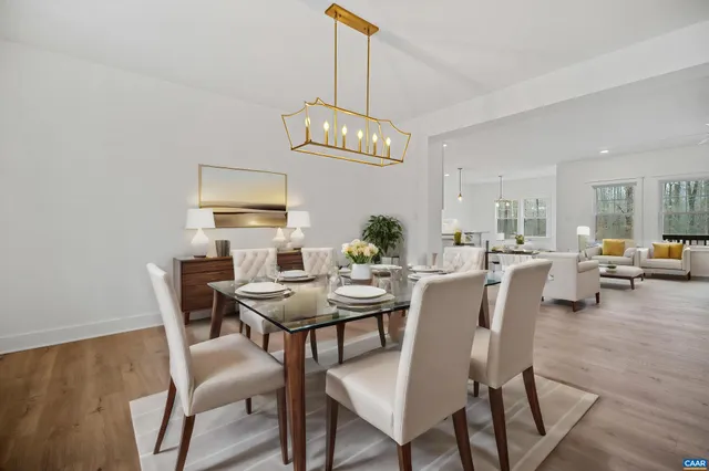 a view of a dining room with furniture and chandelier