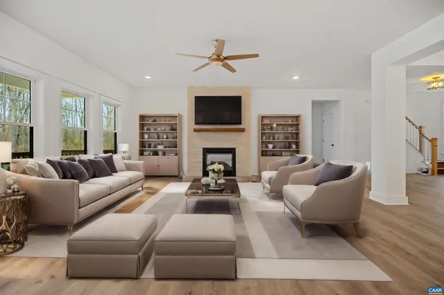 a living room with furniture a fireplace and a flat screen tv