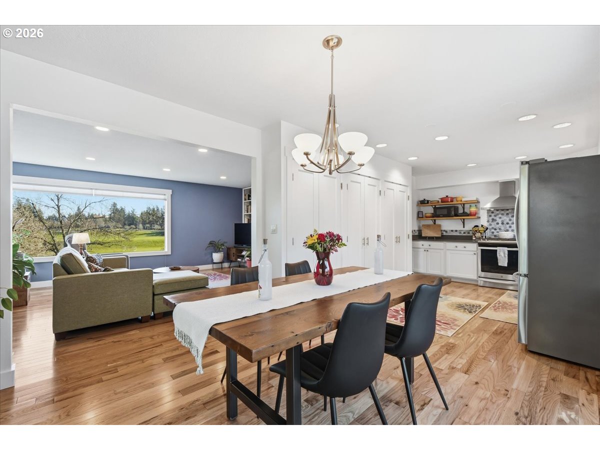 10339 Southwest 40th Avenue Portland, OR 97219 - Photo 11 of 37 a view of a dining room with furniture a chandelier and wooden floor