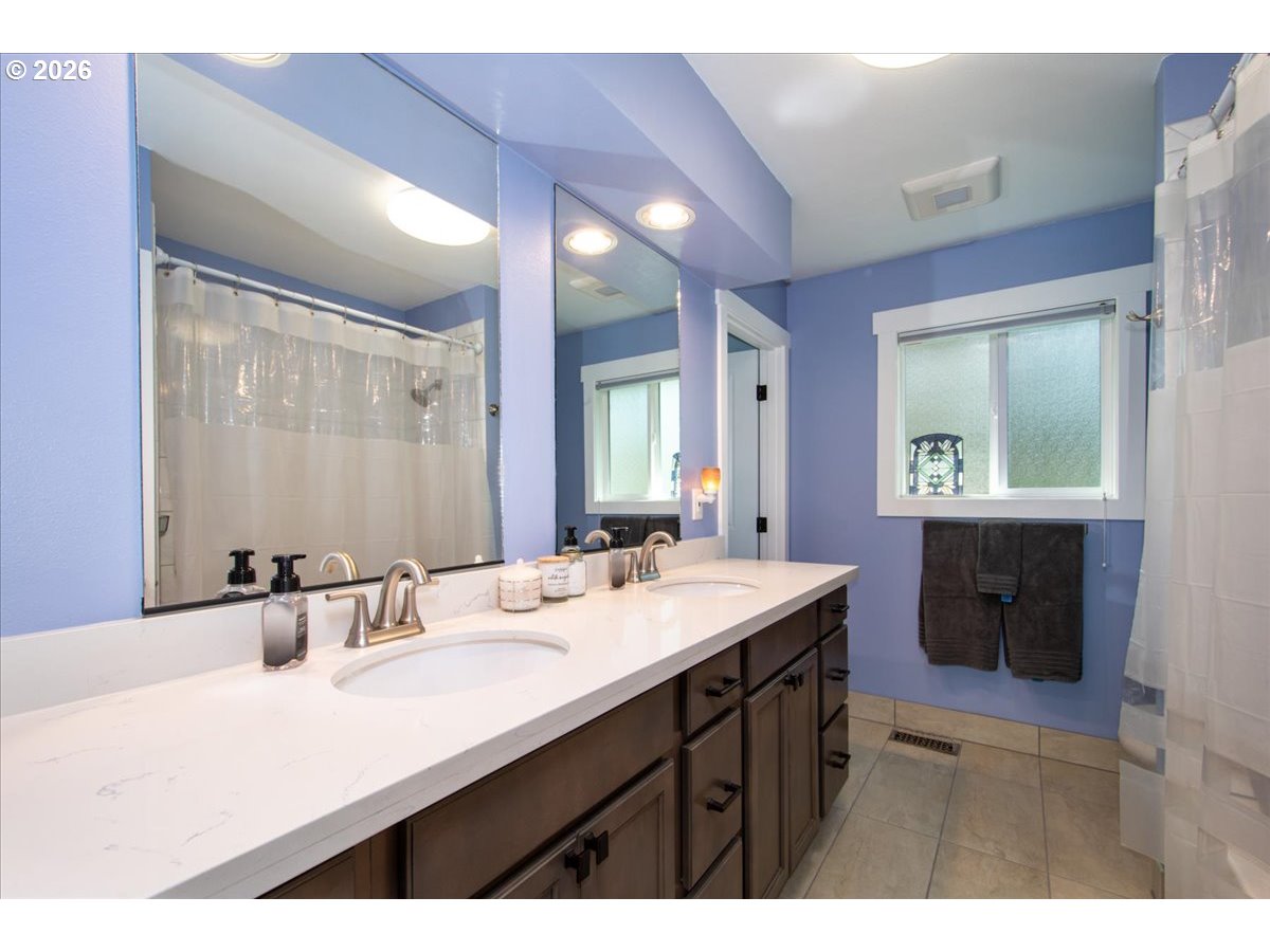 10339 Southwest 40th Avenue Portland, OR 97219 - Photo 18 of 37 a bathroom with a sink double vanity and a mirror