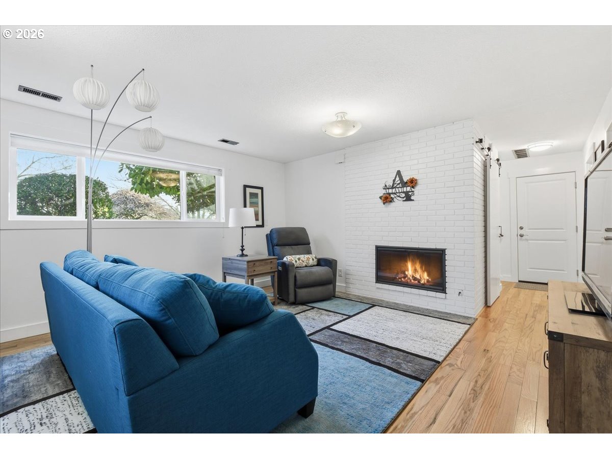 10339 Southwest 40th Avenue Portland, OR 97219 - Photo 23 of 37 a living room with furniture and a fireplace